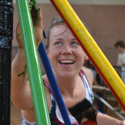 A construction volunteer in Ghana painting a playground structure. A Projects Abroad construction volunteer in Ghana painting a playground.